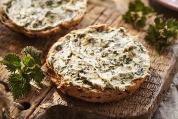 Homemade nettle butter prepared in early spring on a slice of bread