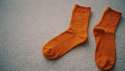 pair of orange socks lying on the floor