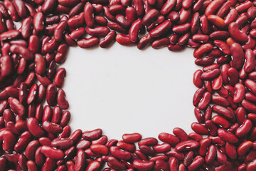 Vibrant red kidney beans are carefully arranged in an oval shape, enclosing a blank space perfect...