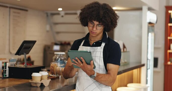 Tablet, man and waiter in coffee shop for inventory checklist online for order with supplier. Stock, restaurant and male barista with digital technology for website update with menu in cafeteria.