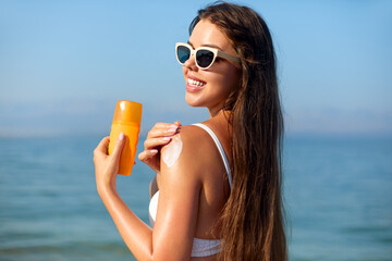 Summer Skincare Routine Featuring Sun Cream at the Beach With a Smiling Person Enjoying Sunny...