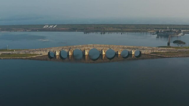 The drone offers impressive views of the historical Suleymaniye Bridge in foggy and sunny weather. The architecture of the bridge and the lake view: history and nature.