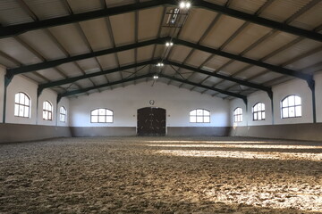 View in an indoor riding hall for horses and riders. The riding school is suitable for dressage and...