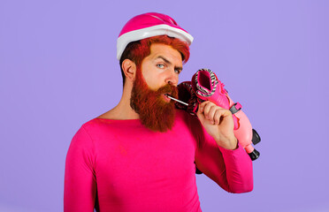 Handsome bearded man in safety helmet with roller skates. Roller skater. Rollerblading. Active...