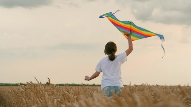 concept happy childhood. Little girl schoolgirl, fly kites into sky, field wheat sunset. child happily runs through field wheat. Children kite game. concept child dream. Children imagination dream