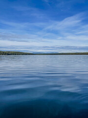 Calm Blue Lake with Gentle Ripples Under Clear Sky