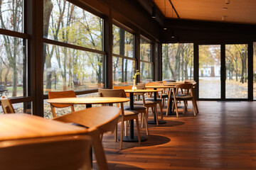 Stylish cafe with large windows and comfortable furniture. Interior design