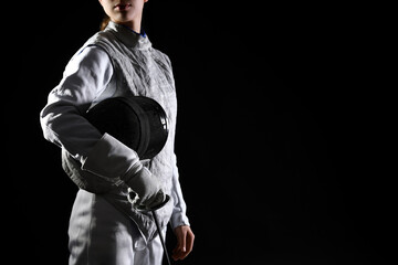 Fencer with epee on black background, closeup. Space for text