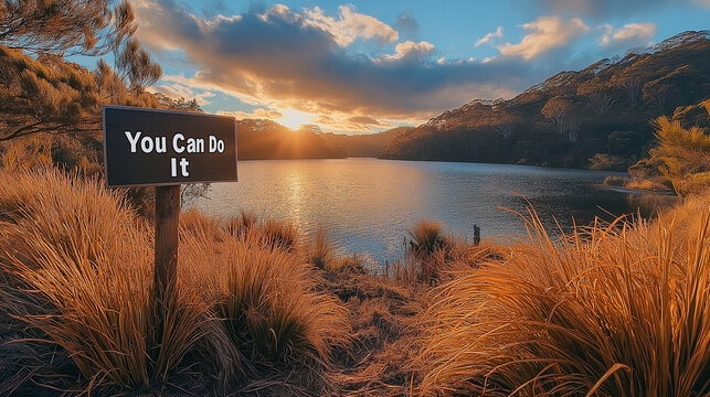 Motivational sunrise scene with "You Can Do It" text over mountains - Powered by Adobe