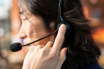 Call center staff member using headphones mic to answer technical inquiries about hardware issues....