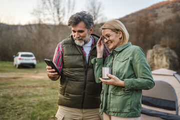 Fototapeta premium mature couple husband and wife use cellphone for fun or exploration