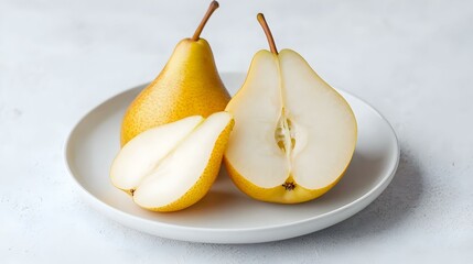 Close-up of pear halves on a white plate studio