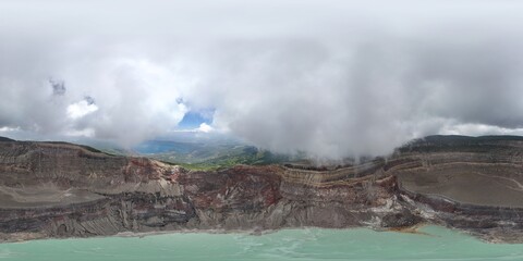 360 aerial photo taken with drone of the inside of the Santa Ana Volcano crater with a blue lake in El Salvador