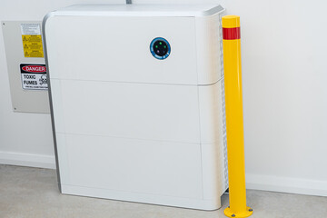 Large white battery for solar energy storage with fire warning sign