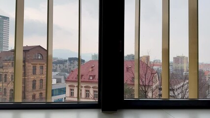 A tranquil and serene cityscape view beautifully showcasing architectural details visible through window bars