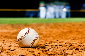 Little League Baseball Close Up with team in background at night game