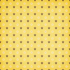 Yellow retro floral seamless pattern with tiny black and white flowers and grid accents, playful repeating design great for crafts, fabric, and wrapping.