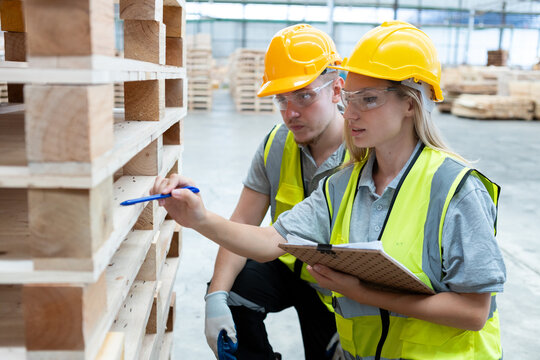 person worker holding clipboard take note report in lumber warehouse during workingtime.