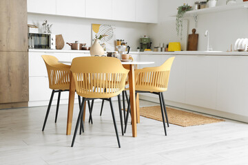 Interior of modern kitchen with table served for breakfast