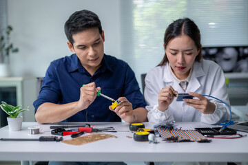 A man and a woman are working on a project together
