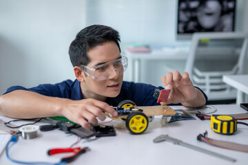 A man is working on a robot