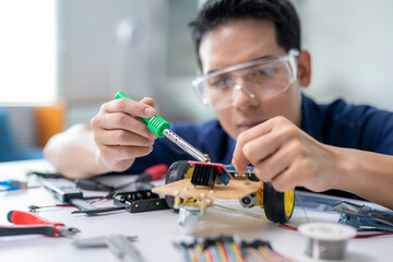 A man is working on a robot