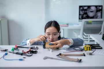 A girl is working on a robot