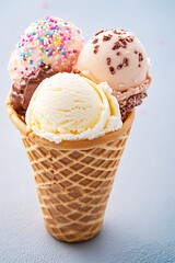ice cream cone with three different flavors of icecream,