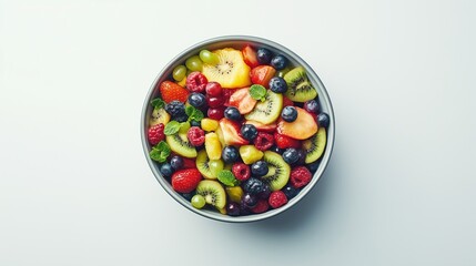 Plate of fresh fruit salad, top view, on a white background, isolate