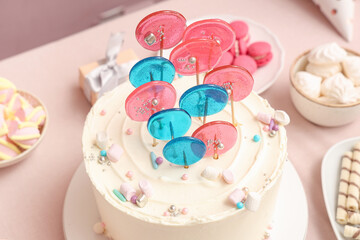 Cake with sweets for birthday party on pink table