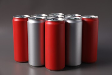 Many aluminium cans of beverage on grey background