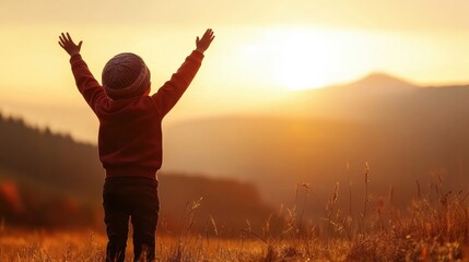 Fototapeta premium Child embracing nature's beauty sunset landscape inspirational scene outdoor rear view freedom concept