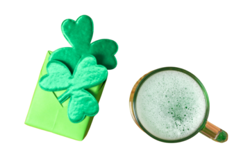 Patrick`s day, gift box decorated with artificial clover leaves and glass of beer isolated on white background, top view, PNG
