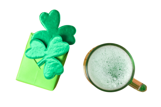 Patrick`s day, gift box decorated with artificial clover leaves and glass of beer isolated on white background, top view, PNG
