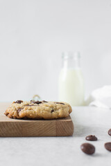 Large chocolate chip cookies on a white countertop, top view of homemade chocolate chip cookies on a white background