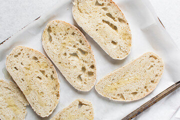 Overhead view of toasted slice of artisan bread, top view of toasted slice of sandwich bread