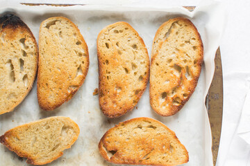 Overhead view of toasted slice of artisan bread, top view of toasted slice of sandwich bread