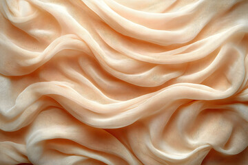 Obraz premium Smooth, flowing fabric drapes in soft peach tones