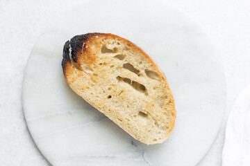 Overhead view of toasted slice of artisan bread, top view of toasted slice of sandwich bread