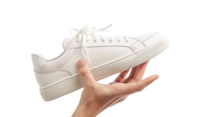 Woman hand holding white sneaker with transparent background