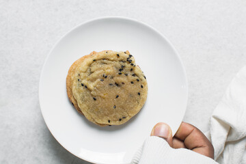 Overhead view of a black sesame sugar cookie, top view of bakery style black sesame cookies