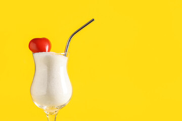 Glass of sugar with heart on yellow background