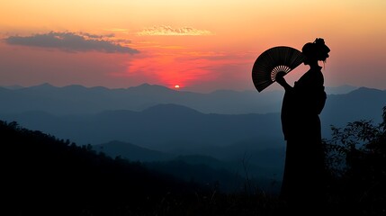 Silhouetted Geisha with Fan at Sunset Over Mountain Range