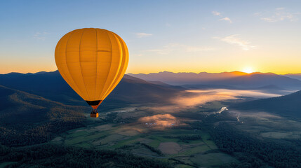Obraz premium lone hot air balloon drifts above misty valley at sunrise, creating serene atmosphere