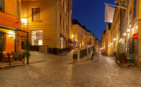 Illuminated cobblestone street in Gamla Stan at night, Stockholm, Sweden - Powered by Adobe