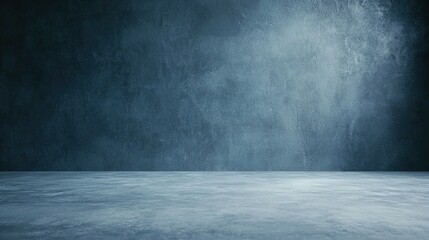 A textured wall above a concrete floor in a dark room