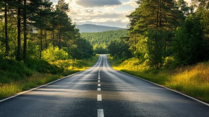 Obraz premium Serene winding road through lush green forests under a cloudy sky, inviting exploration