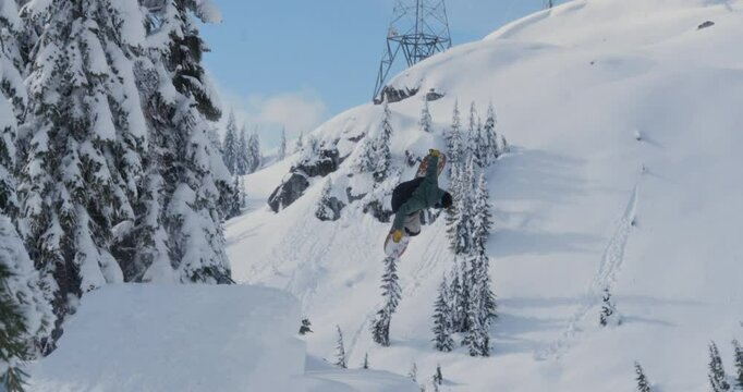 Snowboarder Flipping Off Backcountry Jump Slow Motion