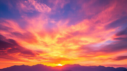 Fototapeta premium stunning sunset over mountains, showcasing vibrant colors in sky, creating dramatic and serene atmosphere. scene captures beauty of nature at dusk