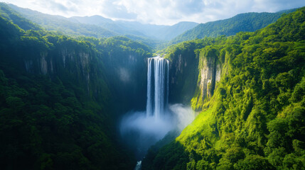 Fototapeta premium breathtaking natural landscape featuring majestic waterfall surrounded by lush greenery and mountains, evoking sense of tranquility and wonder